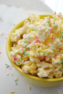 Cake batter popcorn is a super sweet and salty treat, perfect for a birthday party or as a fun Easter snack. This bunny popcorn is flavored with vanilla cake mix, coconut, melted white chocolate chips and plenty of colorful sprinkles! Whether you serve a bowl up to a crowd or hand it out as a party favor, no one can resist this cake batter popcorn!
