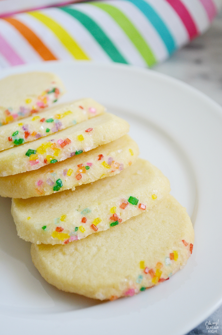Add some sparkle to the holidays, a celebration or any day with these rainbow sparkling butter cookies. This slice and bake sugar cookie recipe is a great option for freezing the dough and baking when convenient. Change out the sparkling sugar colors for any holiday!