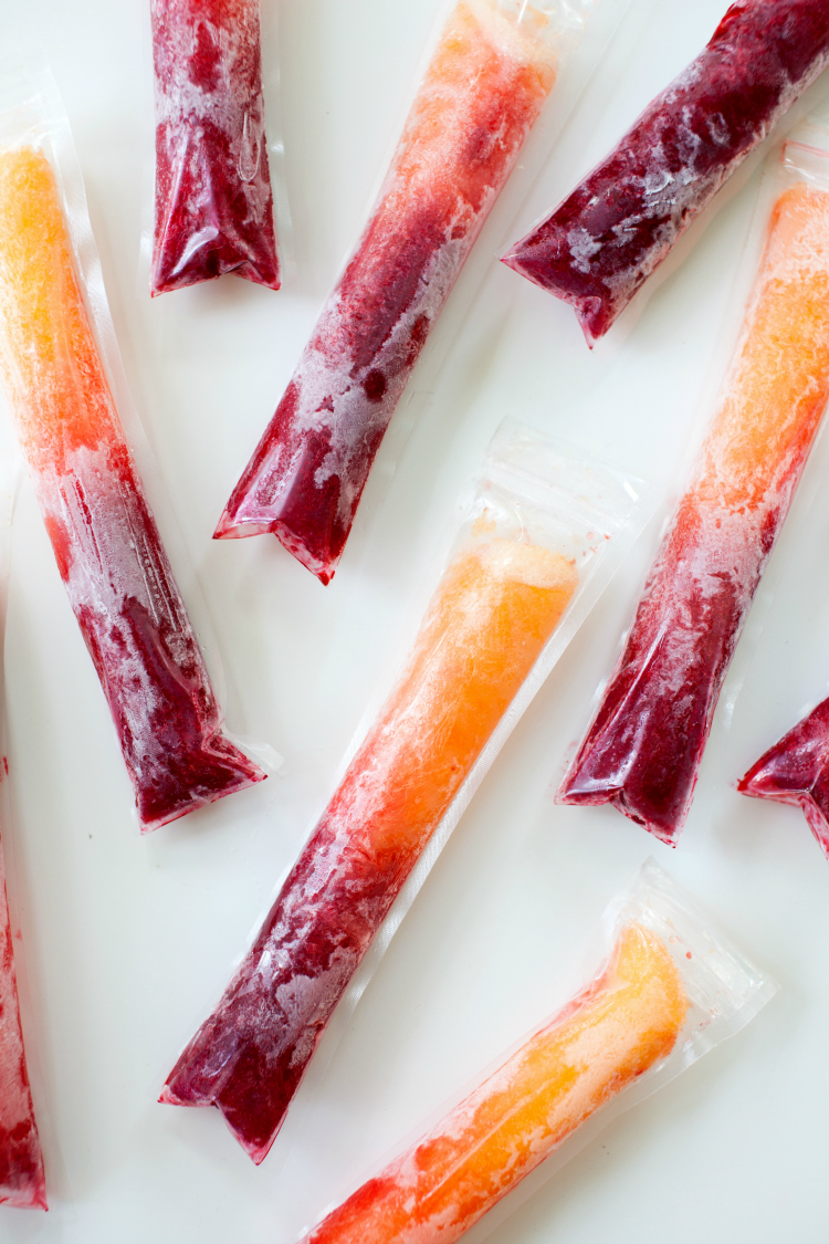 Cool off this summer with these Raspberry Peach Prosecco Ice Pops! Perfect for a hot day, these boozy ice pops are sure to add some sparkle to your day!