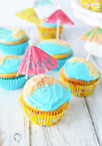 Wow guests and save time with these beach birthday cupcakes decorated with water, sand and colorful umbrellas! These easy cupcakes are perfect for your next birthday party or summer celebration like a pool party, cookout or picnic. #cupcakes #beach #kidparties #birthdayparties #summer #dessert