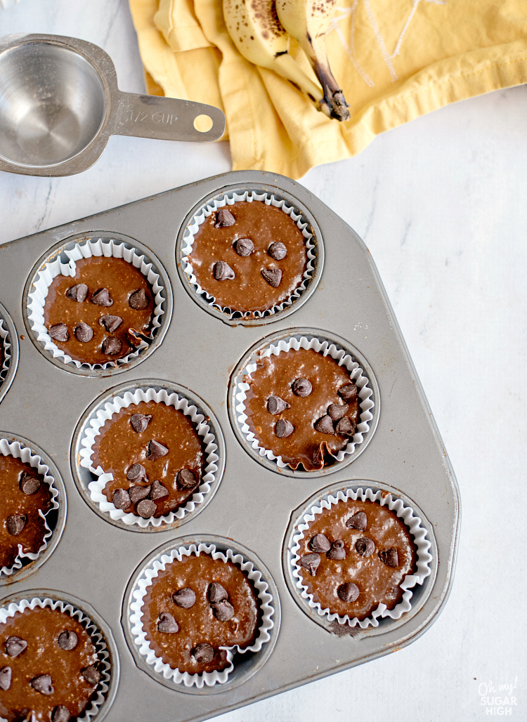 Filled muffin tins with chocolate muffin batter ready to bake