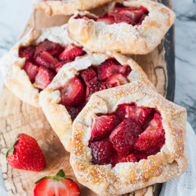 Strawberry Galette is a delicious spring or summer dessert that is easier to make than you might think! Featuring fresh strawberries and a homemade flaky crust, your family will love these mini strawberry pies! 