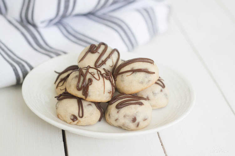 Tea cookies with chocolate chips and chocolate drizzle are the perfect addition to your holiday baking list! Much like a Russian tea cookie, these cookies are moist and dense. Serve them with your favorite tea or coffee!
