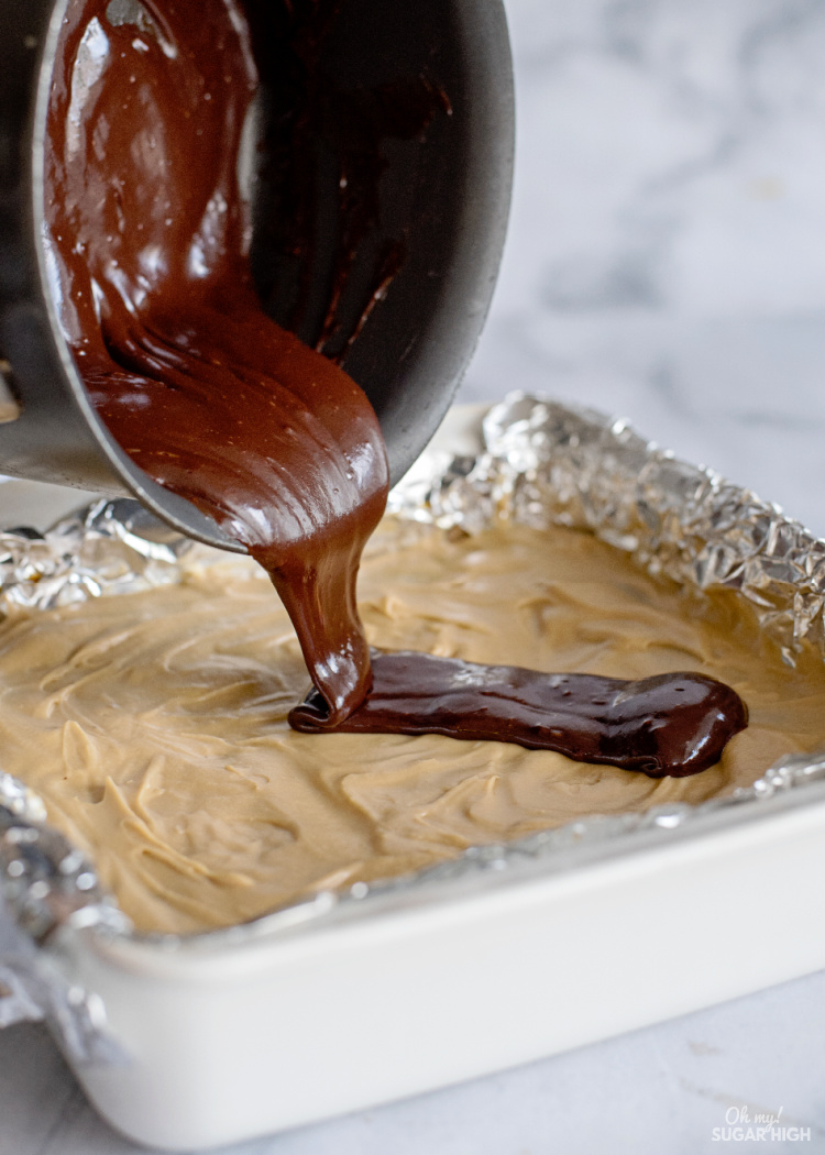 Pouring ganache over the top of brownies from scratch