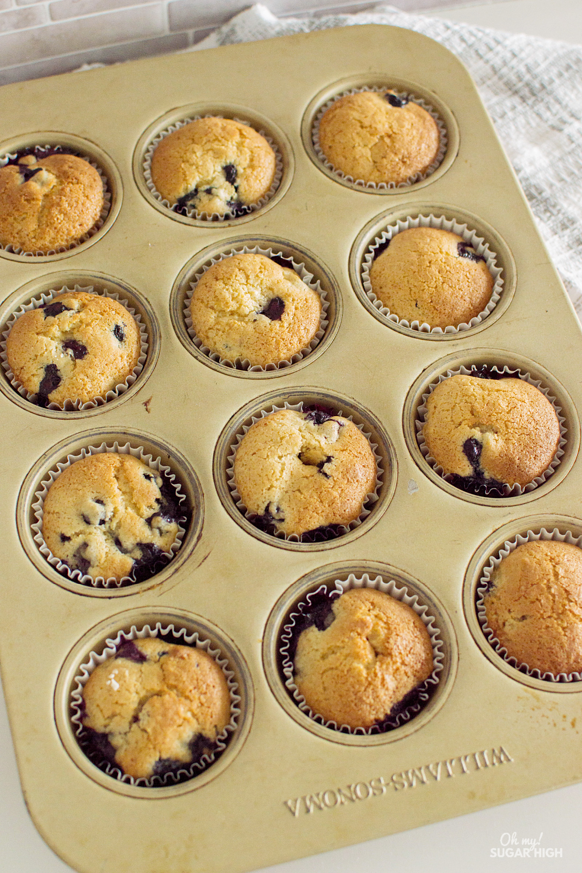 Fresh blueberry muffins in a muffin tin.