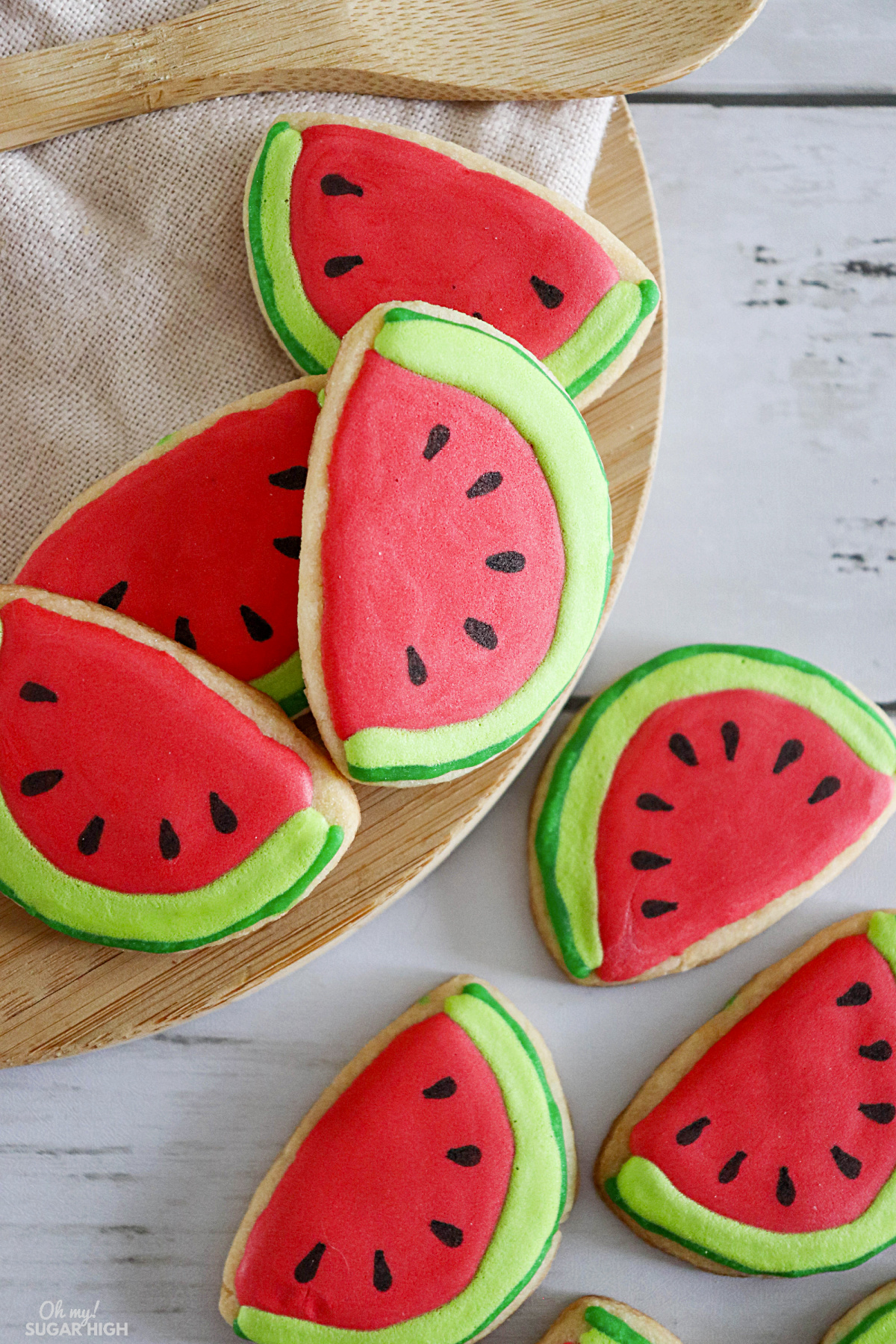 This easy watermelon cookie is perfect for summer. Made with refrigerated sugar cookie dough (or your favorite sugar cookie recipe) and royal icing, this cookie idea is fairly simple to make! 